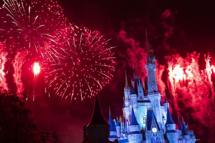 Red fireworks exploding above Cinderella Castle at Walt Disney World